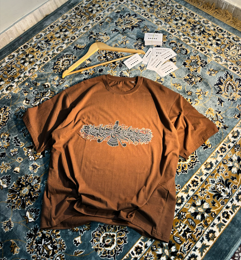 Persian Calligraphy Oversized Tee Brown – flat lay on rug angle 1
