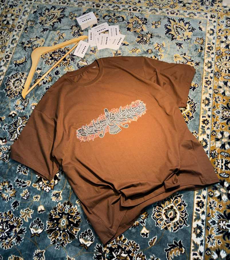 Persian Calligraphy Oversized Tee Brown – flat lay on rug angle 3